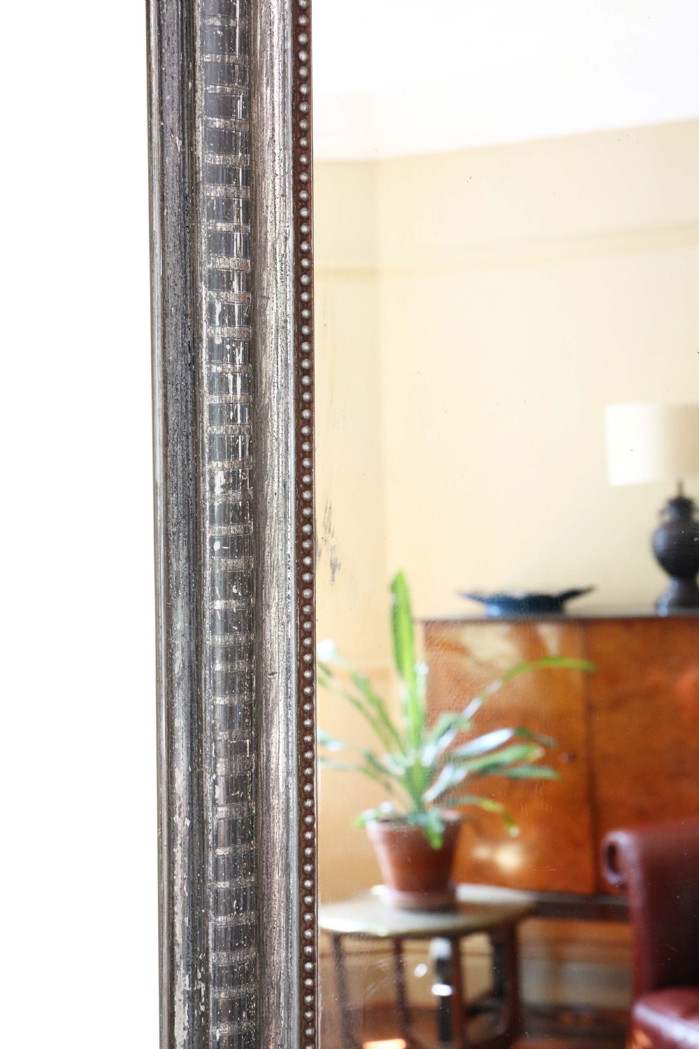 A 19th-century silver gilt overmantel mirror featuring rounded top corners, incised linear moulding, and a beaded inner frame. View IV