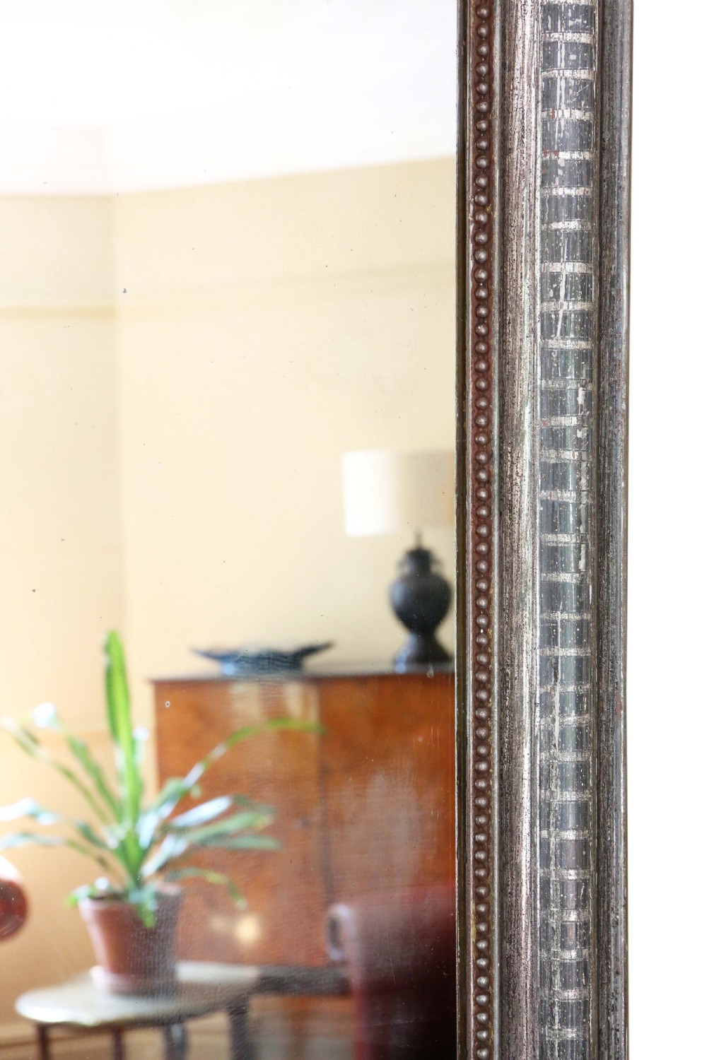 A 19th-century silver gilt overmantel mirror featuring rounded top corners, incised linear moulding, and a beaded inner frame. View V