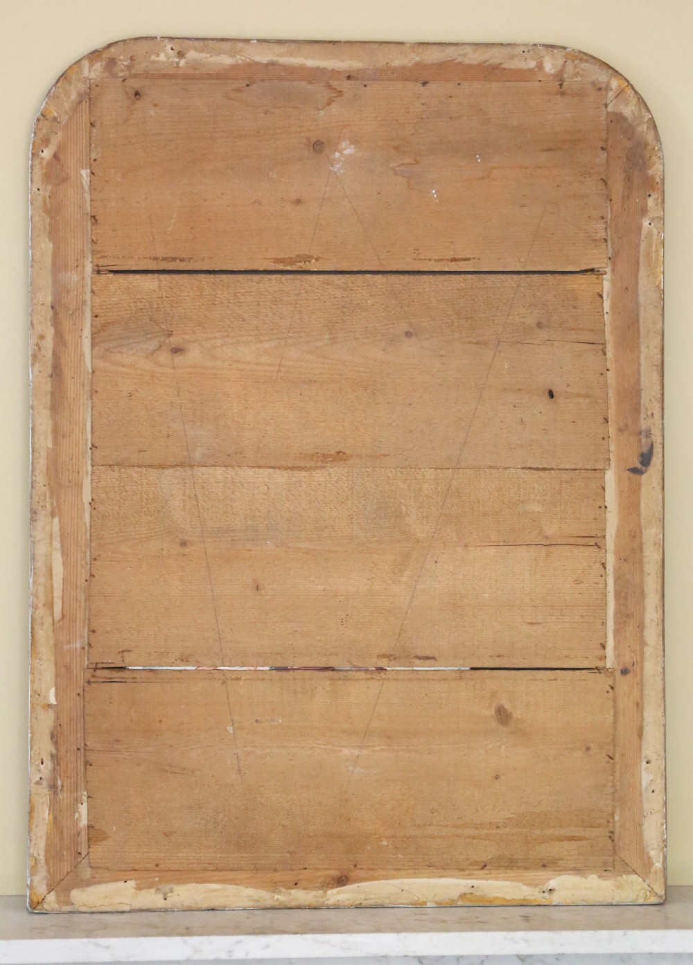 A 19th-century silver gilt overmantel mirror featuring rounded top corners, incised linear moulding, and a beaded inner frame. View VI