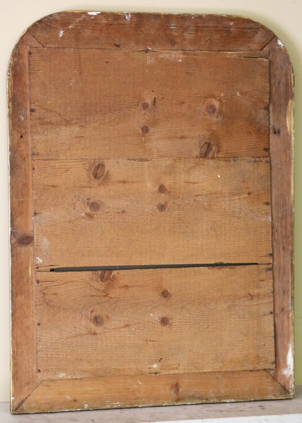 A large 19th-century rectangular wall mirror with rounded upper corners, featuring a gilded and silvered frame with incised floral panels. View IV