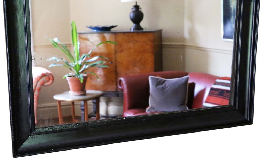 A large rectangular antique wall mirror featuring a simple moulded ebonised black wooden frame. View III