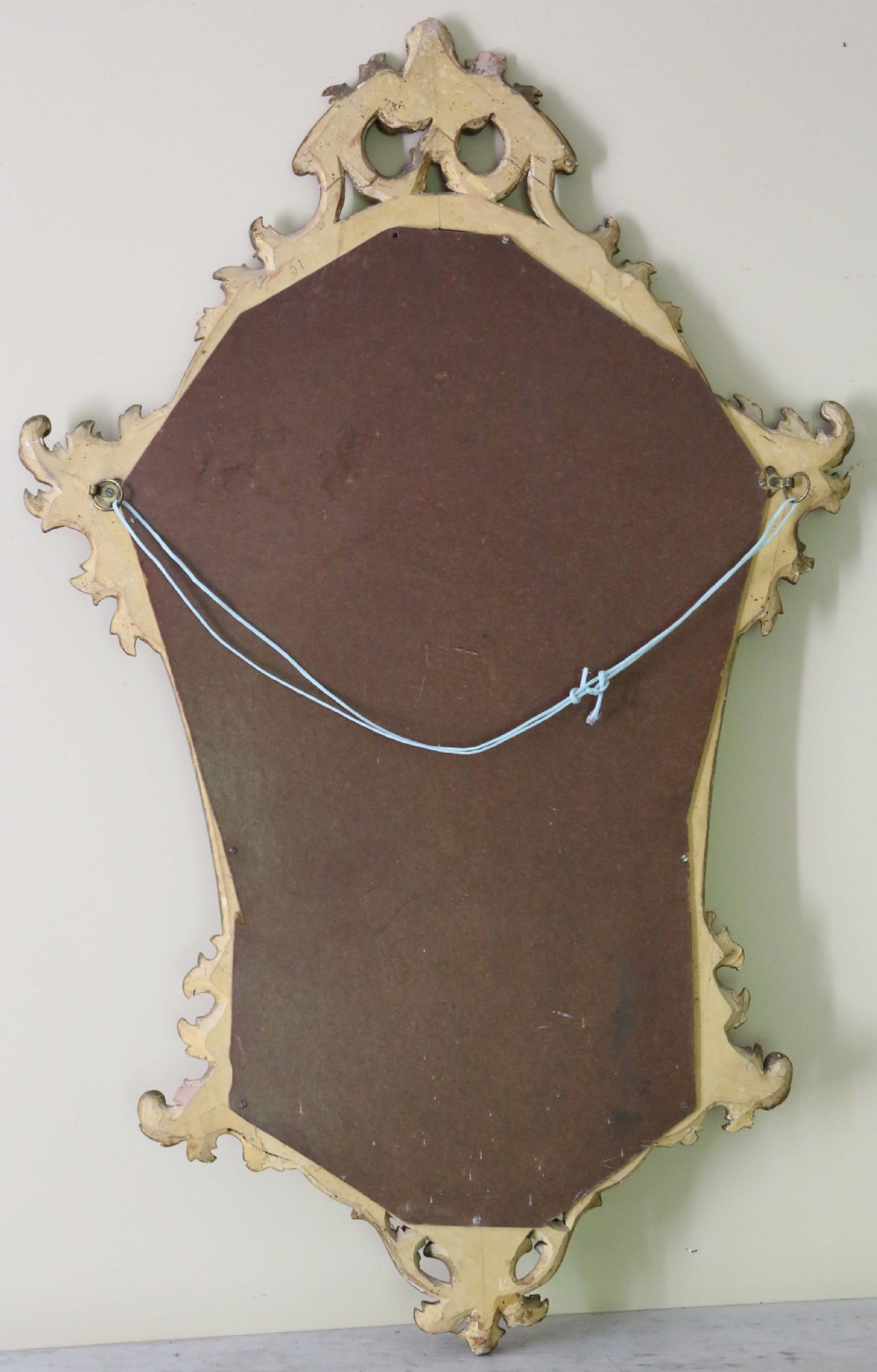 An ornate turn-of-the-century Rococo Revival overmantel mirror featuring a carved gilt wood frame with fluid scrollwork and foliage cresting. View IV