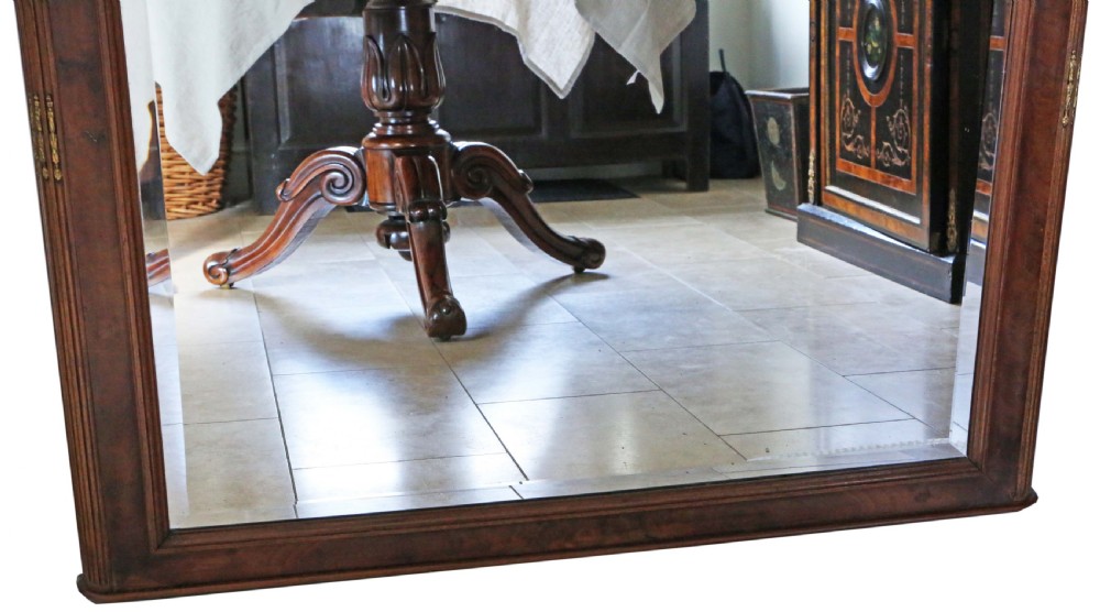 A large early 20th-century mahogany and walnut framed mirror featuring an arched top adorned with a gilt shell motif and corner metal accents. View III