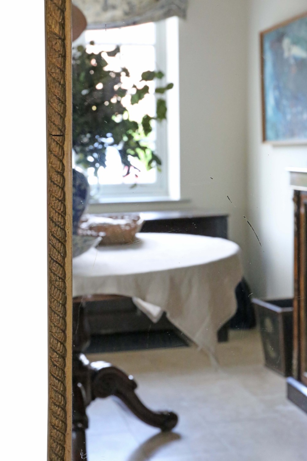 A tall Edwardian full-length mirror featuring a gold leaf rope-twist frame and an ornate looped crest at the top. View IV