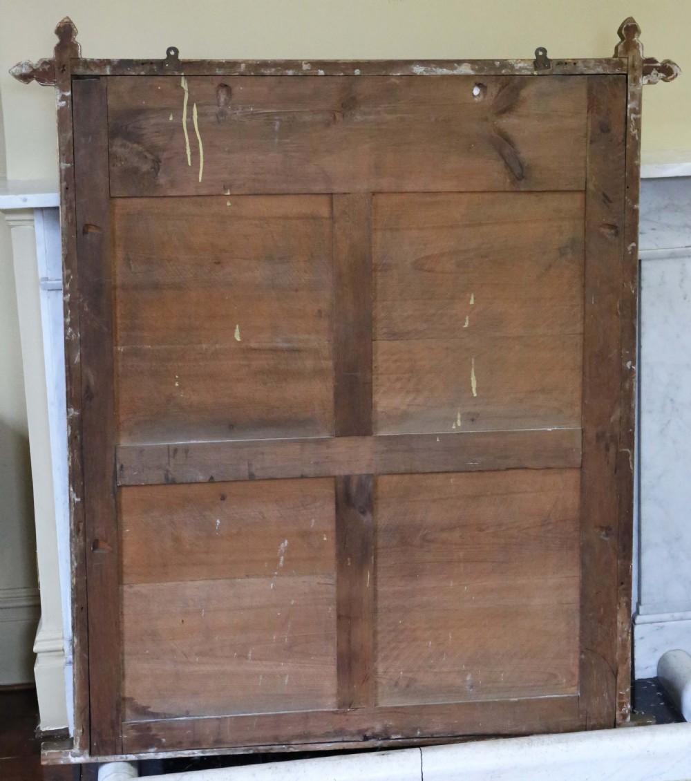 A large nineteenth-century rectangular giltwood overmantel mirror featuring extended corner joints and raised geometric bosses. View VII