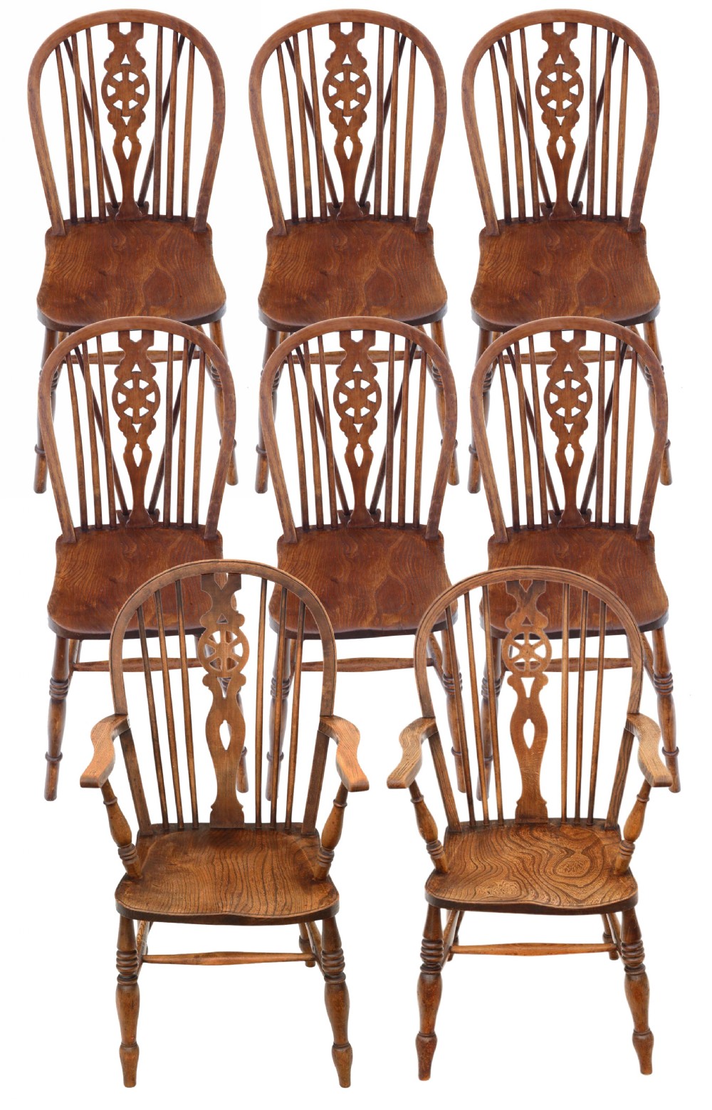 A set of eight matching wooden wheelback Windsor dining chairs, including six side chairs and two carver armchairs, featuring turned legs and shaped elm seats.