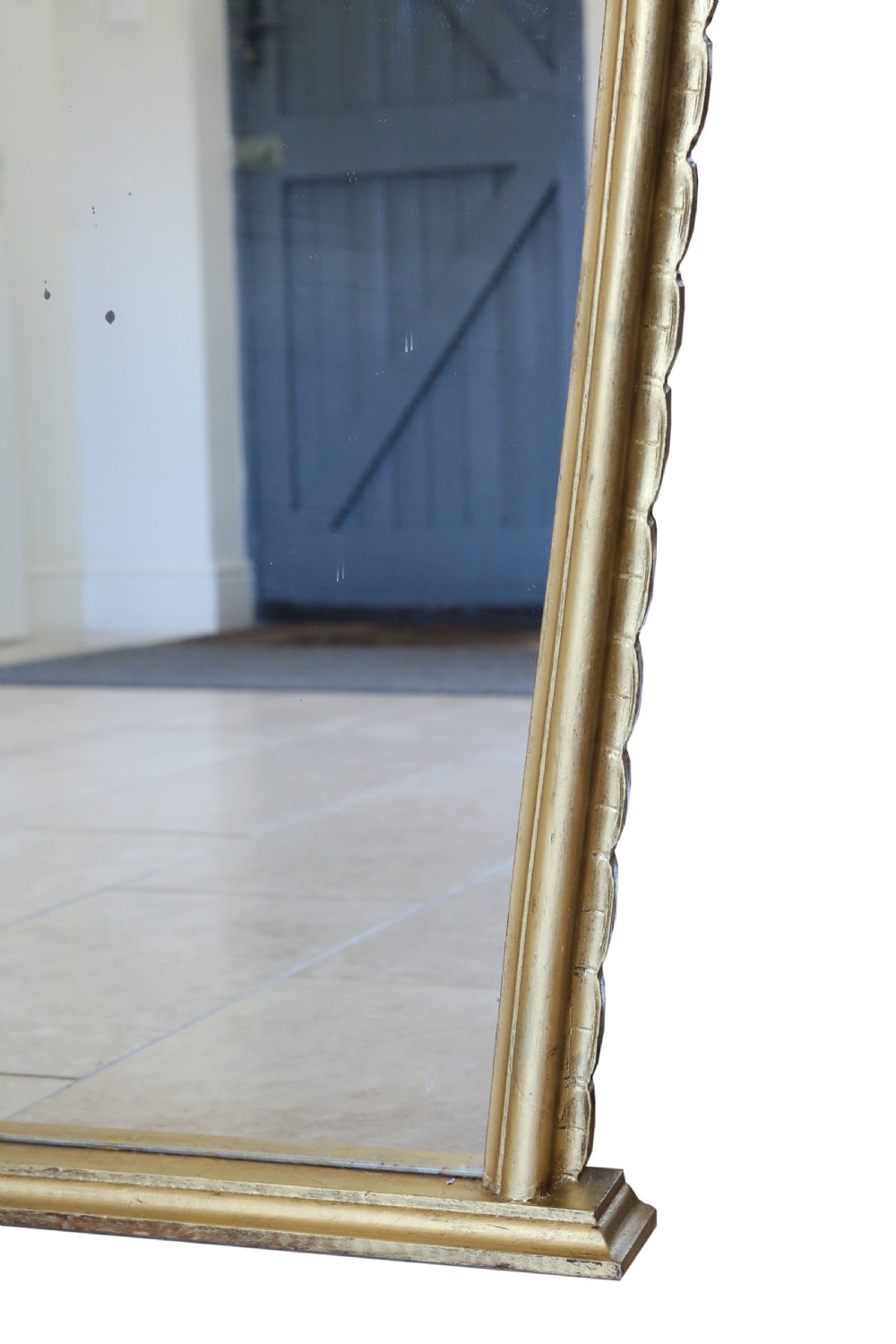 A large Rococo Revival giltwood overmantel wall mirror featuring an ornate carved shell crest, scrolling openwork accents, and a gold leaf finish. View VII