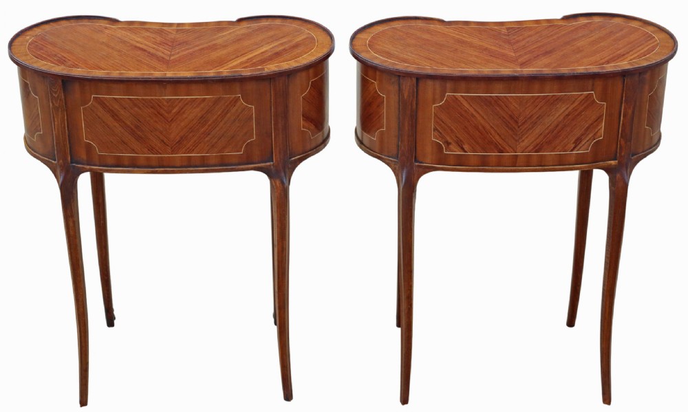 A pair of matching 1920s kidney-shaped timber bedside tables featuring inlaid veneering, central drawers, cabriole legs, and metal knee mounts. View VII