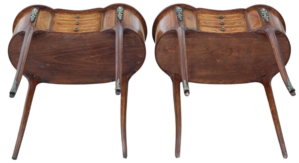 A pair of matching 1920s kidney-shaped timber bedside tables featuring inlaid veneering, central drawers, cabriole legs, and metal knee mounts. View IX