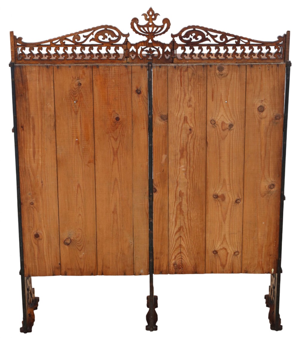 An antique brown oak waterfall bookcase featuring four graduated open shelves with intricate fret-cut scrollwork sides, central dividers, and a decorative cresting top. View VIII