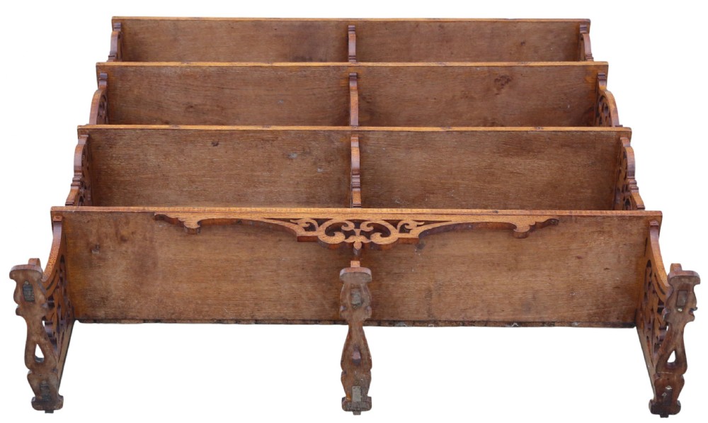 An antique brown oak waterfall bookcase featuring four graduated open shelves with intricate fret-cut scrollwork sides, central dividers, and a decorative cresting top. View IX