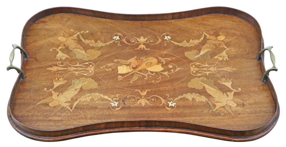 An Edwardian shaped mahogany serving tray featuring intricate marquetry inlay of cherubs and musical instruments with two brass handles. View II