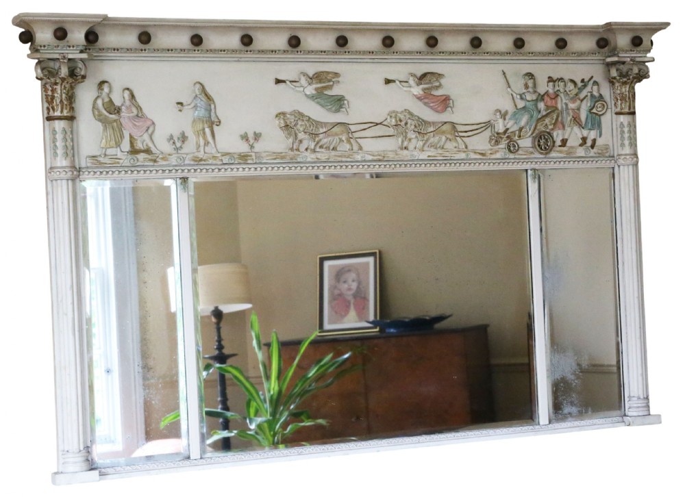 A 19th-century Regency overmantel mirror featuring an off-white painted frame with a classical chariot relief frieze above three mirror plates flanked by fluted pilasters.