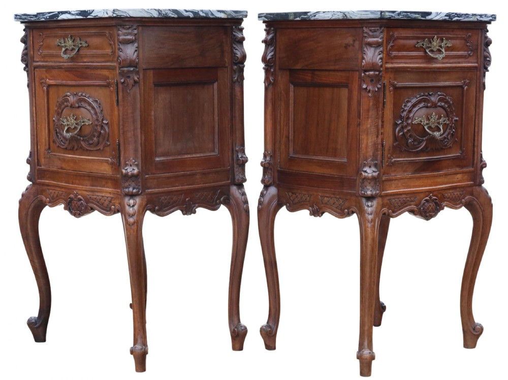A pair of carved walnut bedside tables with dark grey patterned marble tops, single drawers, cupboard doors, and cabriole legs. View V