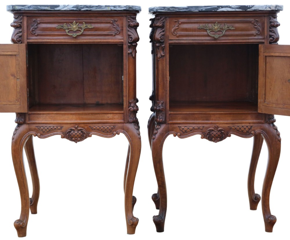 A pair of carved walnut bedside tables with dark grey patterned marble tops, single drawers, cupboard doors, and cabriole legs. View VI