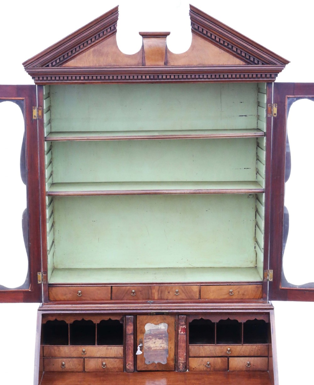 An 18th-century Georgian burr walnut bureau bookcase featuring a broken arch pediment, glazed upper doors, a fall-front desk, and four graduated drawers. View VIII