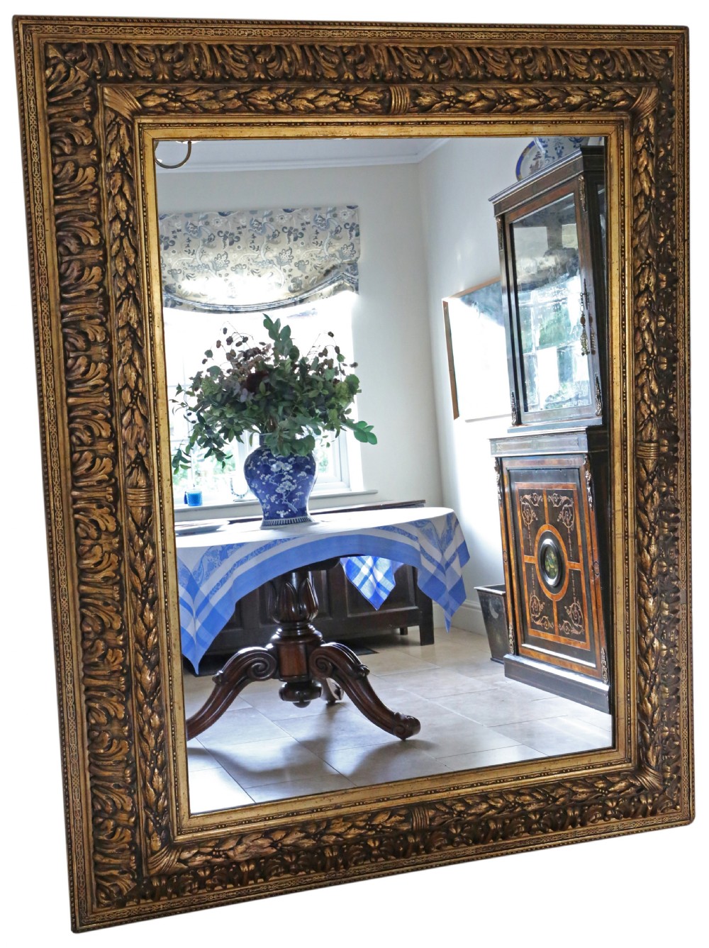A large rectangular 19th-century mirror featuring a wide giltwood frame carved with detailed acanthus leaf and beaded moulding.