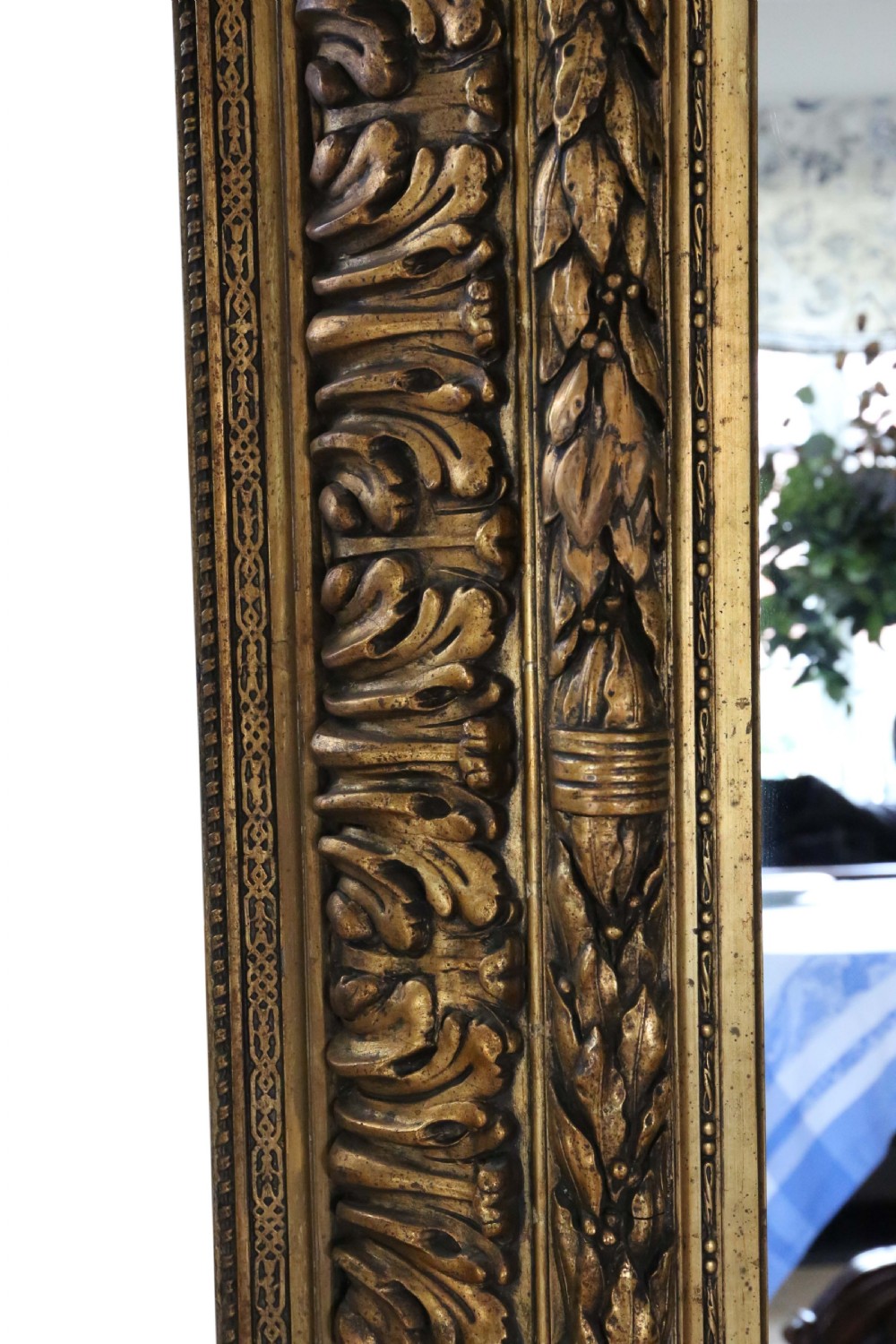 A large rectangular 19th-century mirror featuring a wide giltwood frame carved with detailed acanthus leaf and beaded moulding. View VII