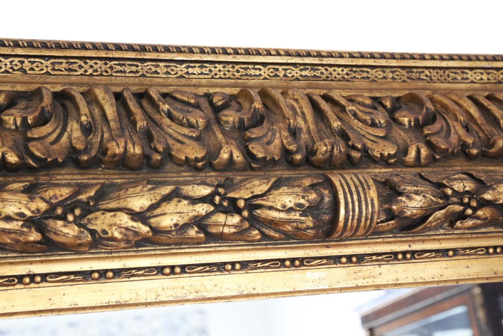 A large rectangular 19th-century mirror featuring a wide giltwood frame carved with detailed acanthus leaf and beaded moulding. View VIII