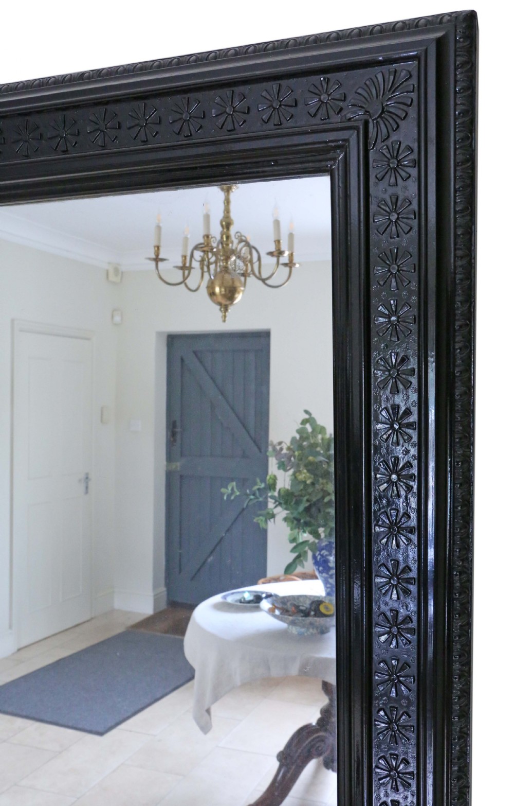 A large, late 19th-century rectangular floor mirror with a wide, ebonised wooden frame decorated with carved rosette mouldings. View IV
