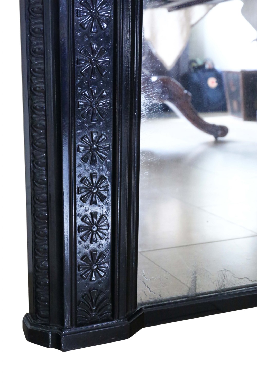 A large, late 19th-century rectangular floor mirror with a wide, ebonised wooden frame decorated with carved rosette mouldings. View VI