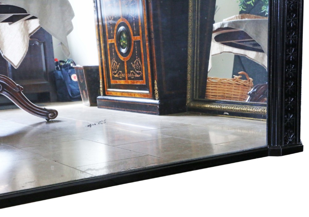 A large, late 19th-century rectangular floor mirror with a wide, ebonised wooden frame decorated with carved rosette mouldings. View VII