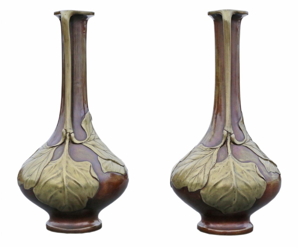 A pair of tall Japanese Meiji era mixed metal bronze vases featuring elongated necks, handles, and cast leaf relief details around the bulbous base. View IV