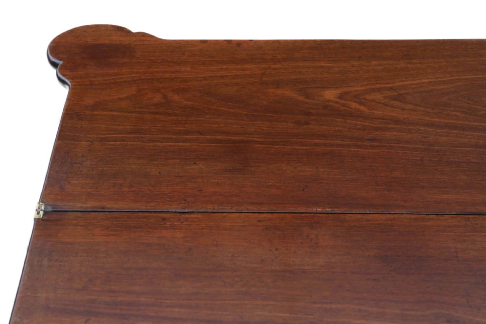 A George II mahogany folding tea table featuring a shaped fold-over top, a single drawer with a brass keyhole escutcheon, and carved cabriole legs ending in pad feet. View VIII