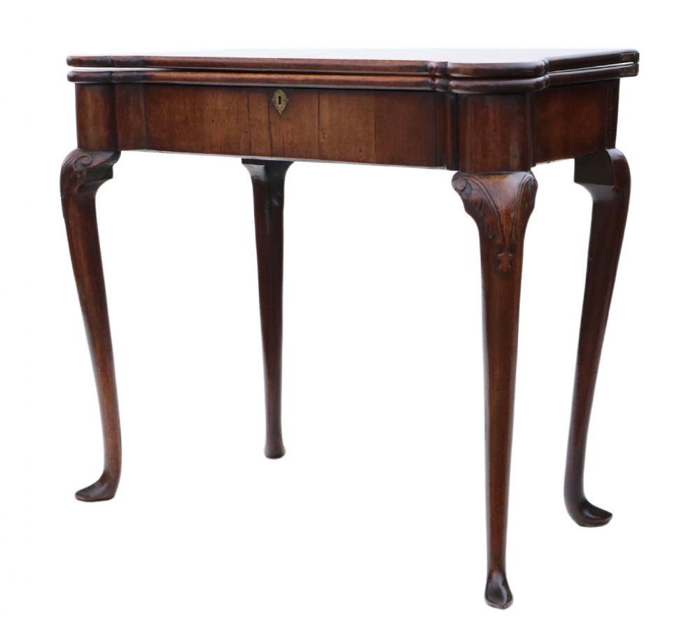 A George II mahogany folding tea table featuring a shaped fold-over top, a single drawer with a brass keyhole escutcheon, and carved cabriole legs ending in pad feet. View XII