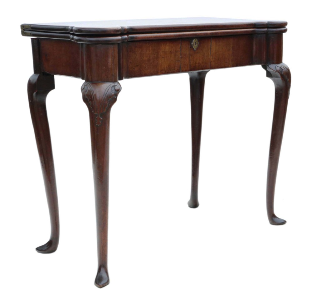 A George II mahogany folding tea table featuring a shaped fold-over top, a single drawer with a brass keyhole escutcheon, and carved cabriole legs ending in pad feet. View XIII