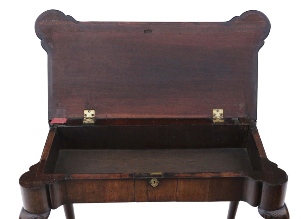 A George II mahogany folding tea table featuring a shaped fold-over top, a single drawer with a brass keyhole escutcheon, and carved cabriole legs ending in pad feet. View XIV