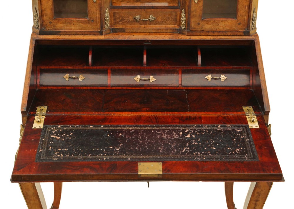 A 19th-century burr walnut bonheur de jour featuring floral marquetry inlay, cabriole legs, brass mounts, and a twin-cabinet upper superstructure with a central mirror. View III