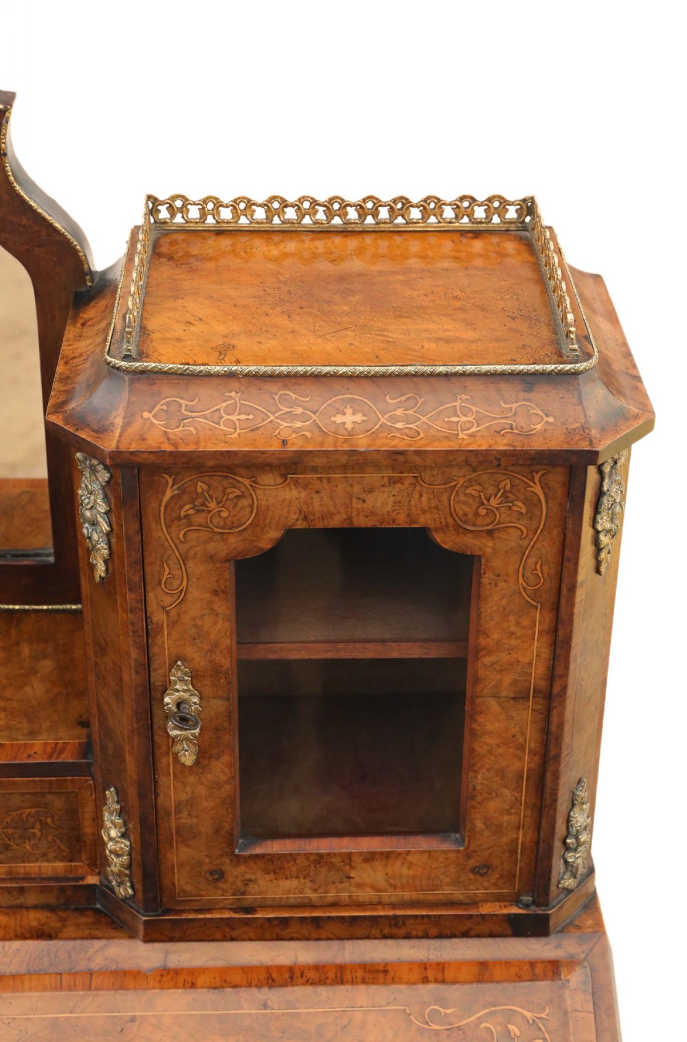 A 19th-century burr walnut bonheur de jour featuring floral marquetry inlay, cabriole legs, brass mounts, and a twin-cabinet upper superstructure with a central mirror. View VI