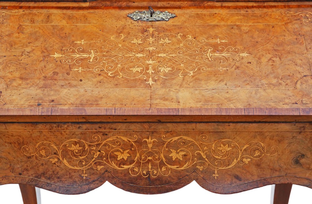 A 19th-century burr walnut bonheur de jour featuring floral marquetry inlay, cabriole legs, brass mounts, and a twin-cabinet upper superstructure with a central mirror. View VIII