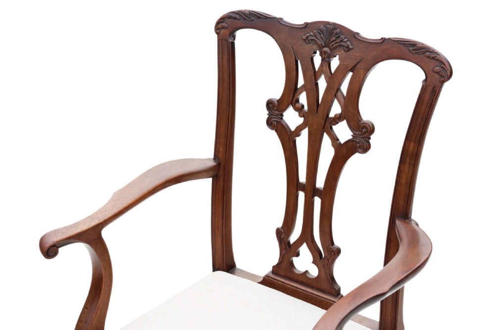 A set of eight Georgian Revival mahogany dining chairs featuring carved pierced splats, cabriole legs with ball-and-claw feet, and white upholstered seats. View VI