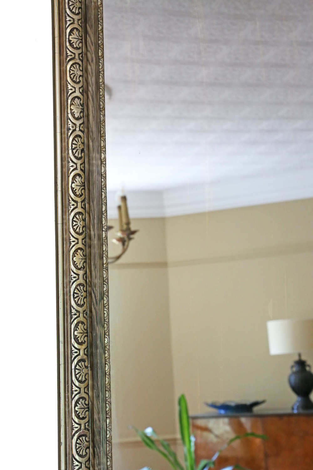 A large rectangular antique gilt mirror featuring a central cherub crest, acanthus scrollwork, and an anthemion pattern frame. View IV