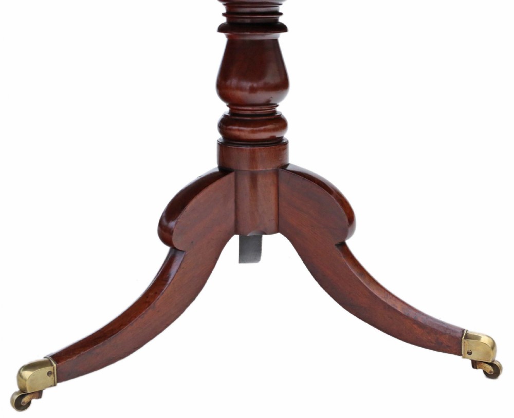 An early 19th century mahogany extending dining table with two pedestal bases, splayed legs, and brass castors. View VII
