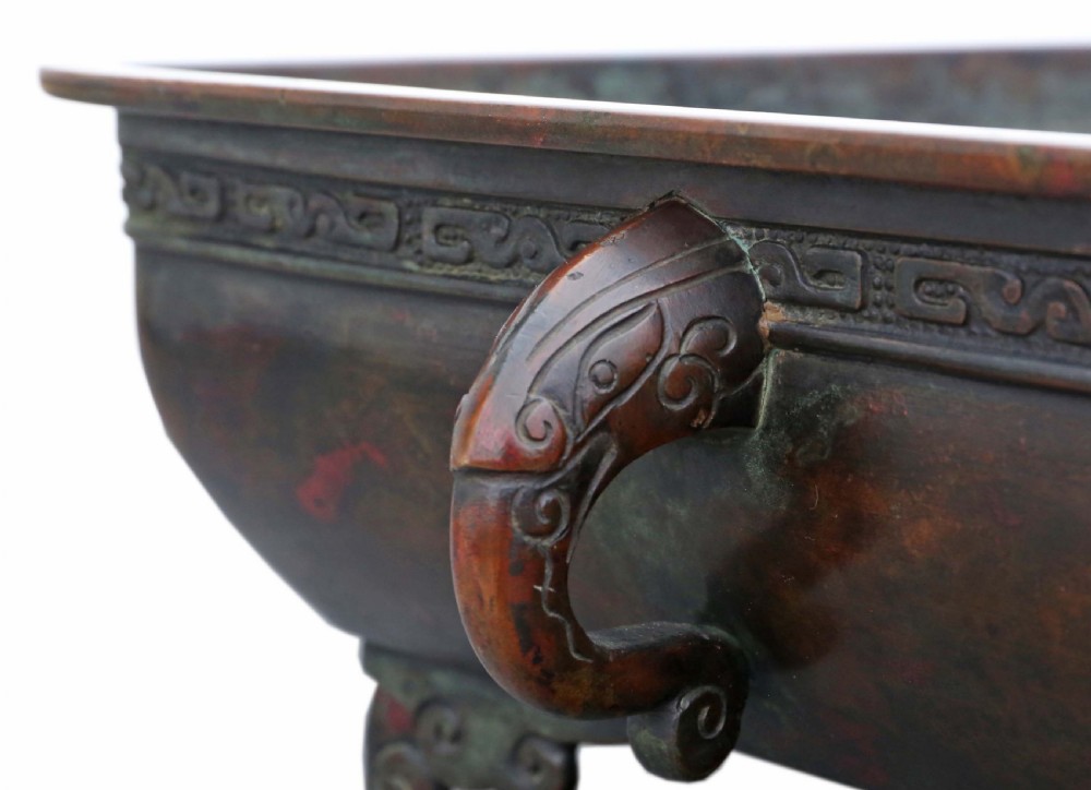 A rectangular dark reddish brown patinated bronze planter with a carved key fret rim border, side handles, and four scroll feet. View III