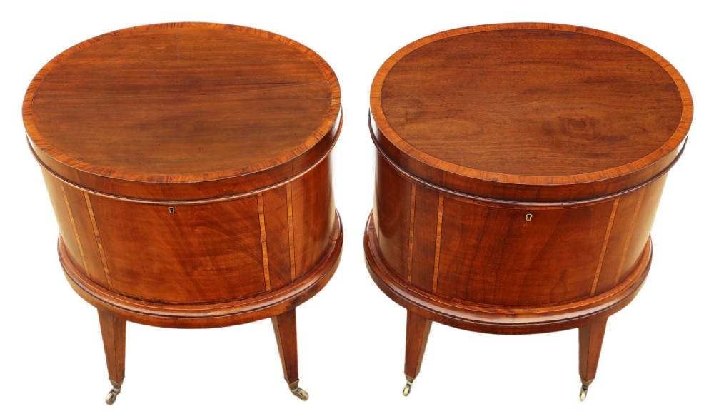 A pair of 19th-century oval mahogany cellarettes with line inlay, escutcheons, tapered legs, and brass castors. View II