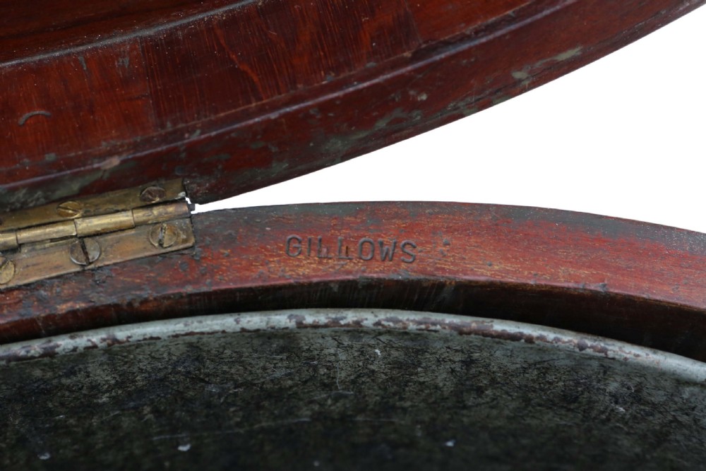 A pair of 19th-century oval mahogany cellarettes with line inlay, escutcheons, tapered legs, and brass castors. View VI