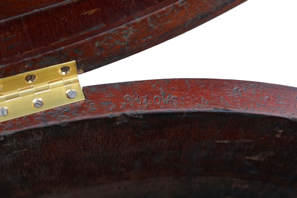 A pair of 19th-century oval mahogany cellarettes with line inlay, escutcheons, tapered legs, and brass castors. View VII