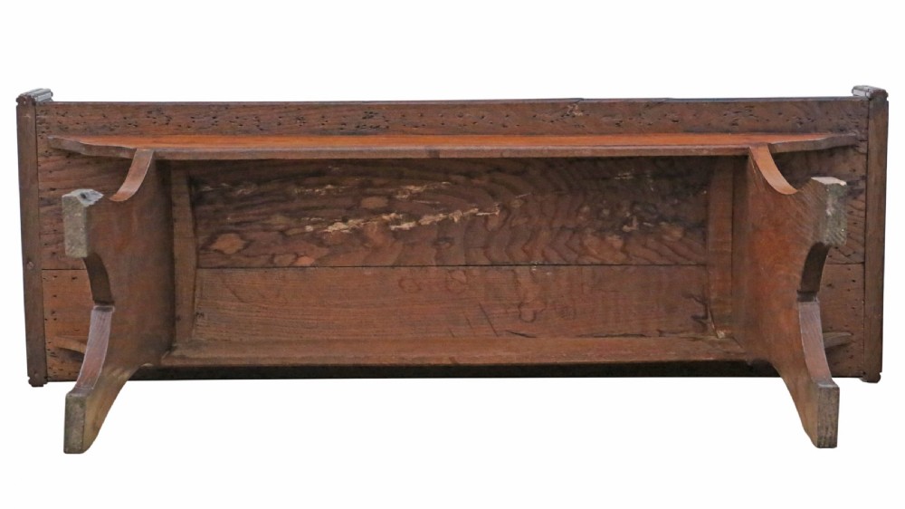 A 19th-century Arts and Crafts oak and elm window seat with pierced geometric gallery ends and solid shaped legs. View V