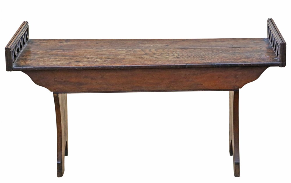 A 19th-century Arts and Crafts oak and elm window seat with pierced geometric gallery ends and solid shaped legs. View VI