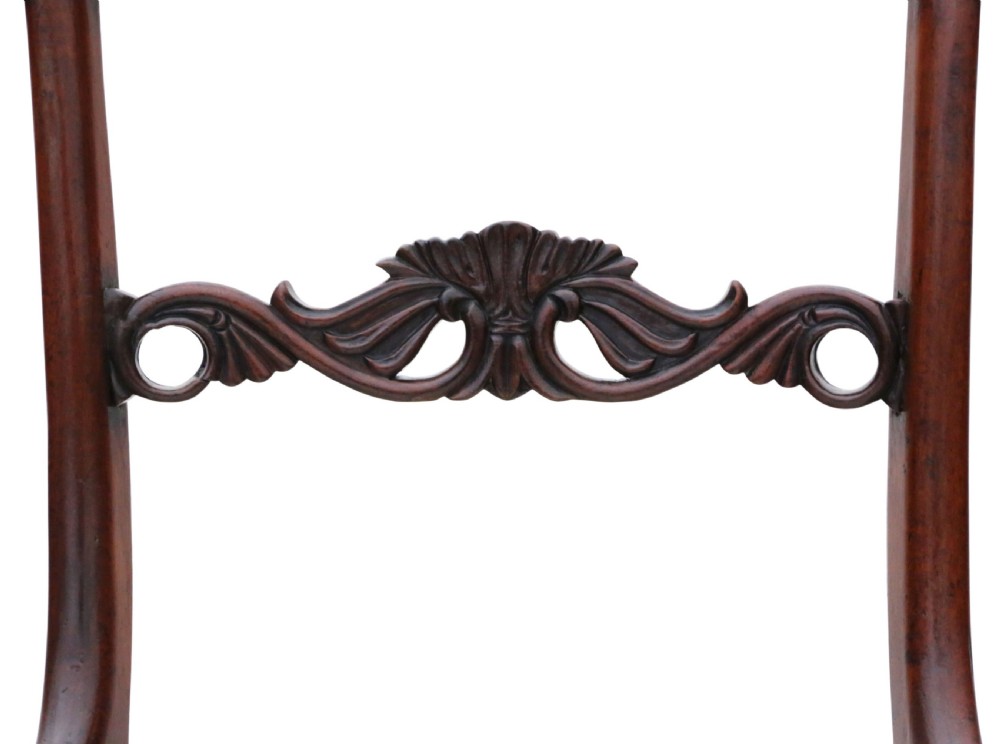 A set of eight antique mahogany dining chairs including six side chairs and two carvers with carved scroll backrests, white upholstered seats, and reeded front legs. View IX