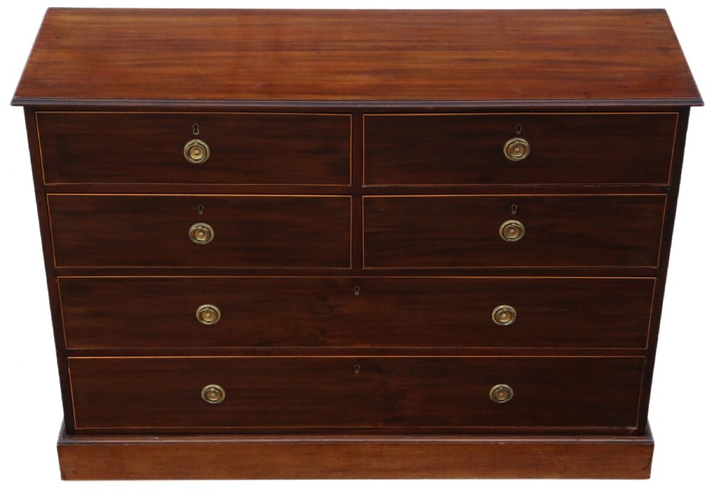 A 19th-century dark mahogany chest of drawers with decorative string inlay, brass ring handles, and a solid plinth base. View II