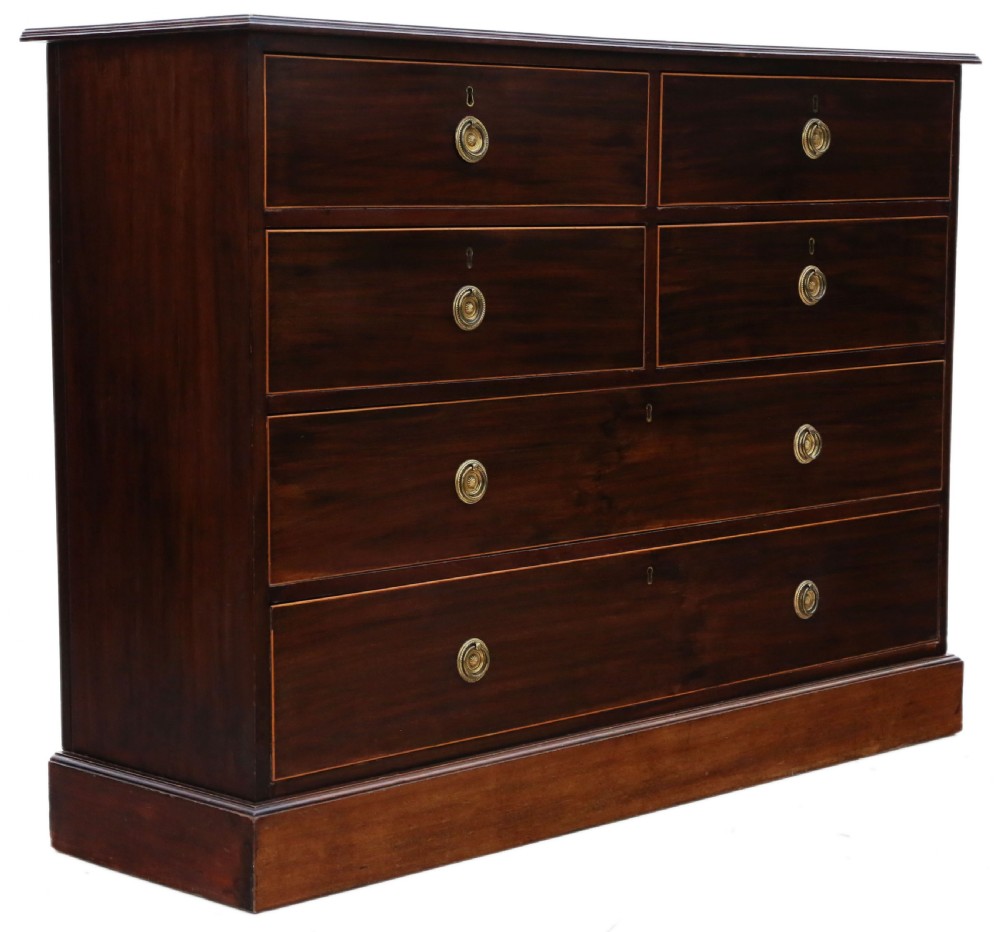 A 19th-century dark mahogany chest of drawers with decorative string inlay, brass ring handles, and a solid plinth base. View III