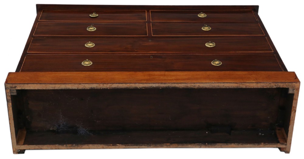 A 19th-century dark mahogany chest of drawers with decorative string inlay, brass ring handles, and a solid plinth base. View VIII