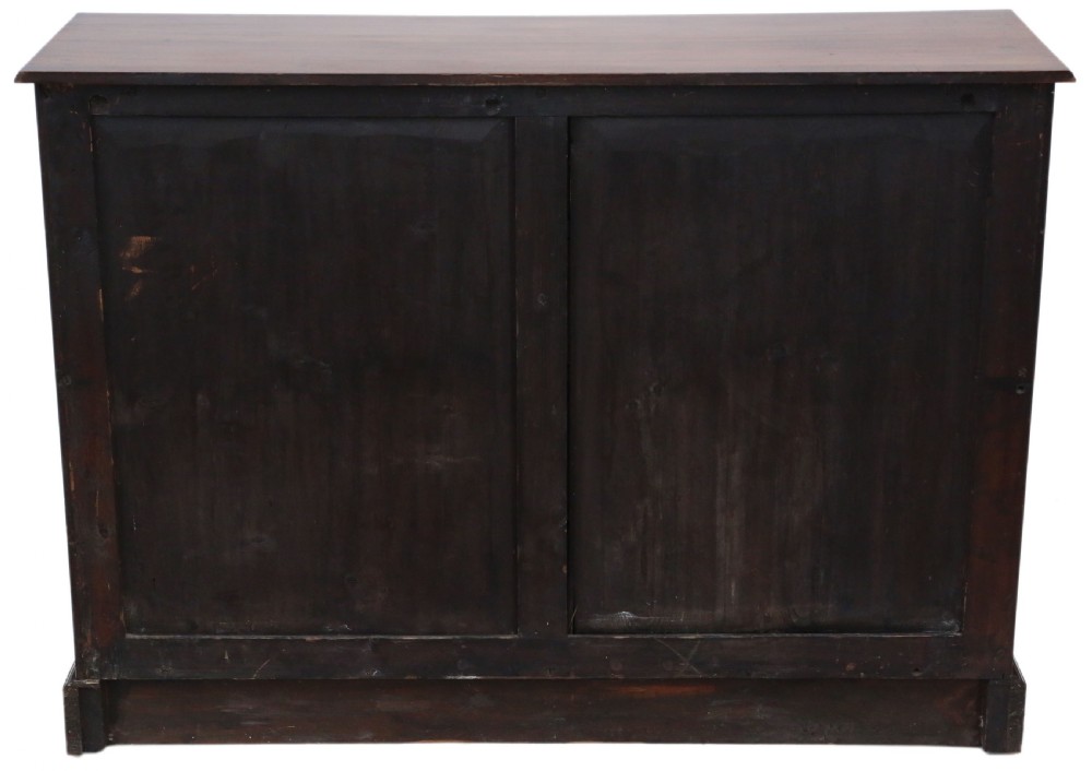 A 19th-century dark mahogany chest of drawers with decorative string inlay, brass ring handles, and a solid plinth base. View IX