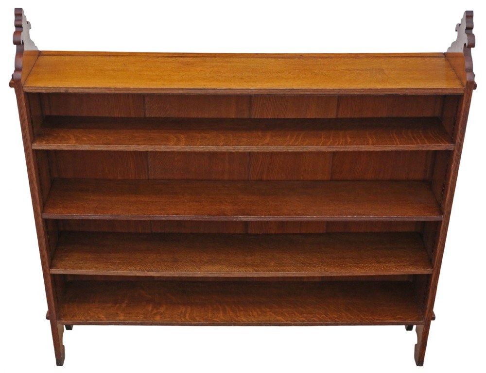 A 19th-century medium oak open bookcase featuring gothic shaped sides with cutout motifs and adjustable internal shelves. View II
