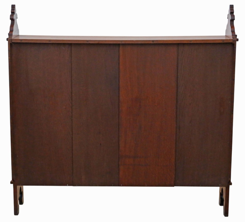 A 19th-century medium oak open bookcase featuring gothic shaped sides with cutout motifs and adjustable internal shelves. View V